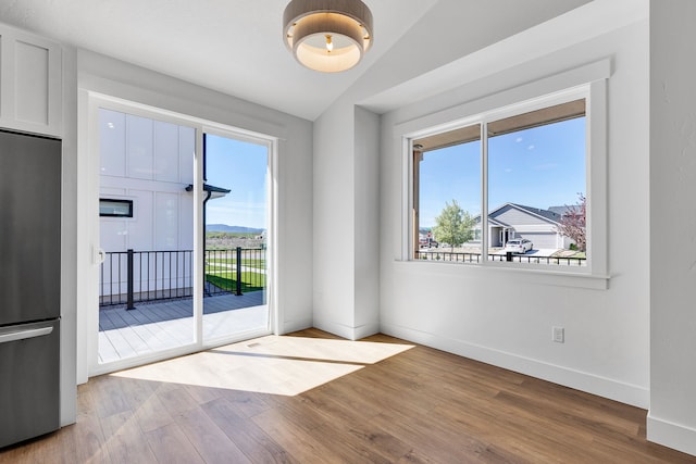 5665 Cattle Dr, Missoula, MT 59808 - spare room with wood finished floors, baseboards, and vaulted ceiling