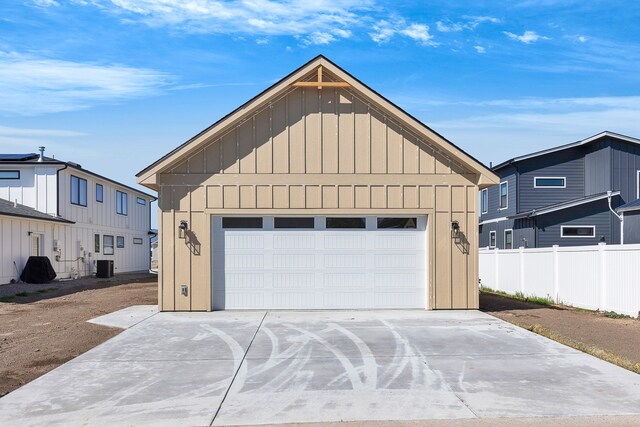 5665 Cattle Dr, Missoula, MT 59808 - garage featuring central AC unit and fence