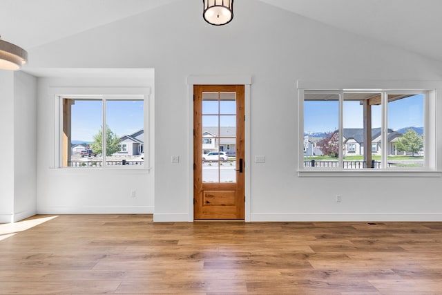 5665 Cattle Dr, Missoula, MT 59808 - entryway featuring vaulted ceiling, wood finished floors, and baseboards