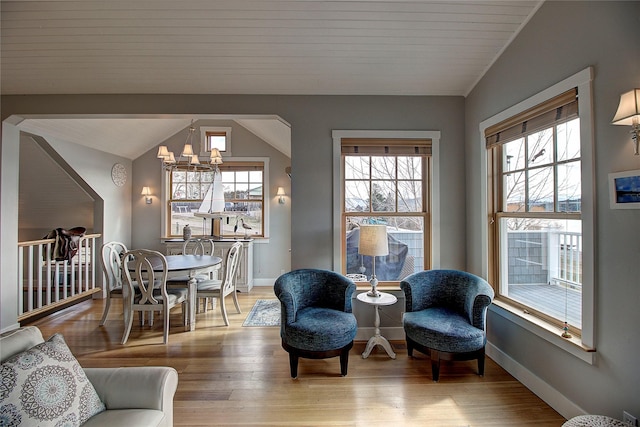 23877 3rd St, Dayton, MT 59914 - living room with a chandelier, vaulted ceiling, and light wood-type flooring