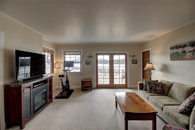 23877 3rd St, Dayton, MT 59914 - living room featuring light carpet, ornamental molding, and a glass covered fireplace
