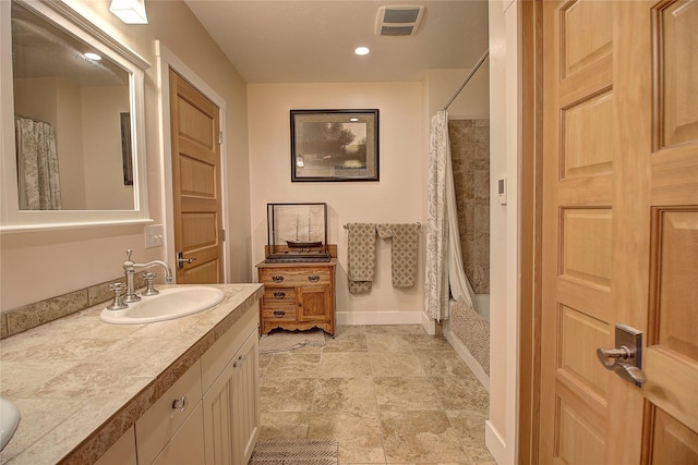 23877 3rd St, Dayton, MT 59914 - full bath with double vanity, stone finish floors, and shower / tub combo with curtain