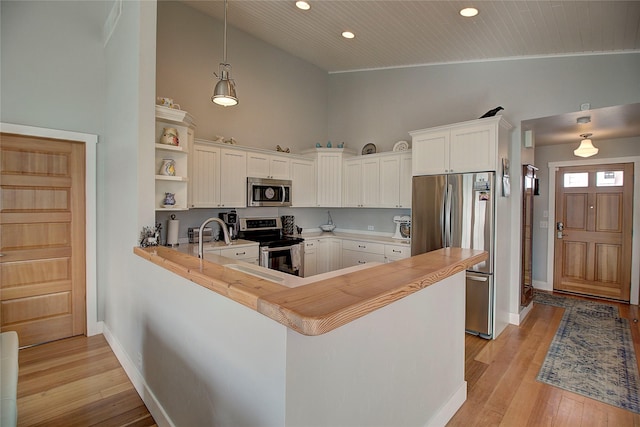 23877 3rd St, Dayton, MT 59914 - kitchen with stainless steel appliances, light wood finished floors, white cabinets, a peninsula, and recessed lighting