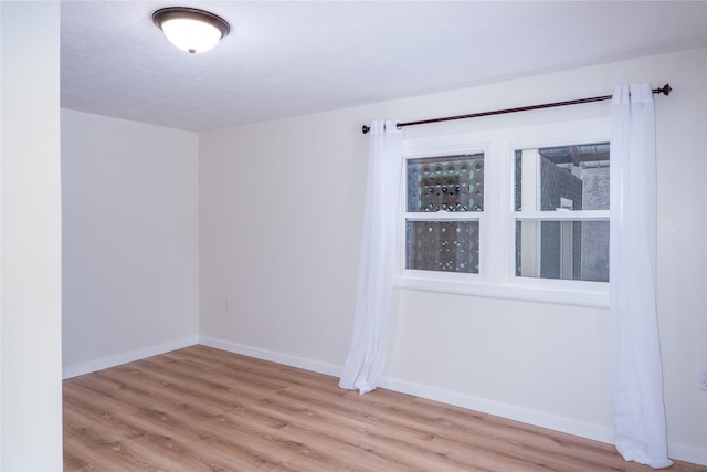 1613 Main Ave, Libby, MT 59923 - spare room with wood finished floors and baseboards