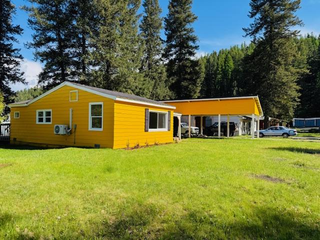 1613 Main Ave, Libby, MT 59923 - rear view of property featuring a lawn and a cooling unit