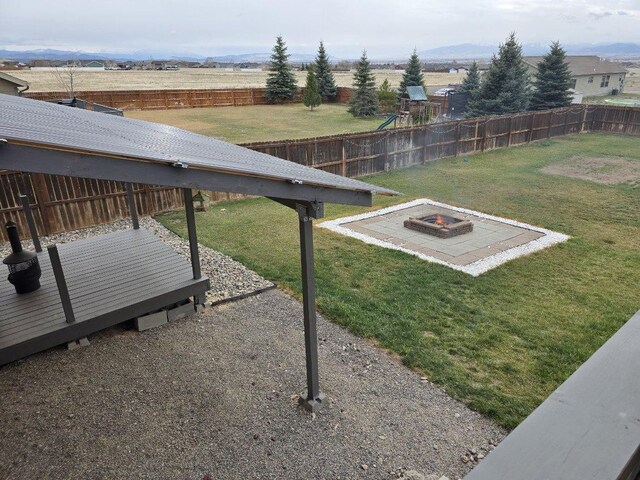 873 Guthrie Rd, Helena, MT 59602 - view of yard with a fire pit, a fenced backyard, and a playground
