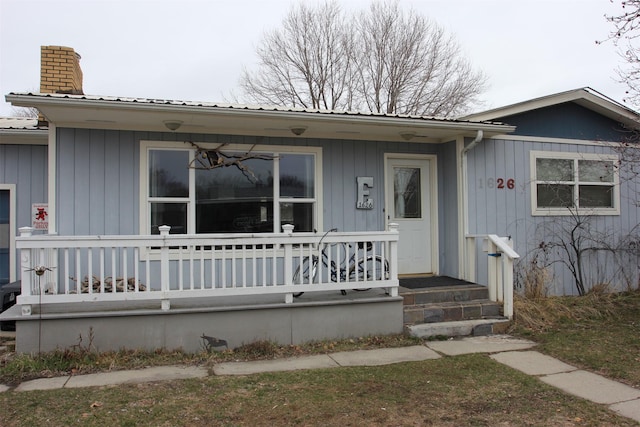 1626 W Central Ave, Missoula, MT 59801 - view of front facade with covered porch, a chimney, and a metal roof