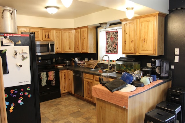 1626 W Central Ave, Missoula, MT 59801 - kitchen featuring stainless steel microwave, freestanding refrigerator, black electric range oven, stone finish floors, and dishwashing machine