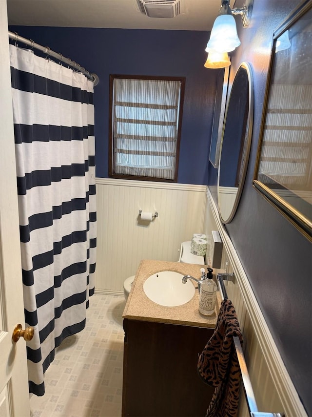 1626 W Central Ave, Missoula, MT 59801 - bathroom featuring a wainscoted wall, vanity, and a shower with shower curtain