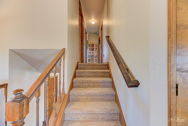 stairway with carpet flooring and baseboards