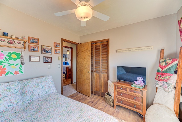 bedroom featuring wood finished floors, a closet, and ceiling fan