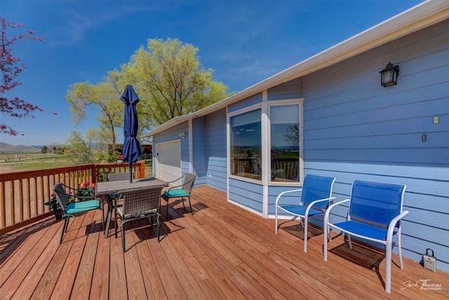 wooden terrace featuring outdoor dining area