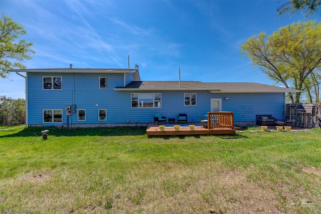 back of house featuring a deck and a yard