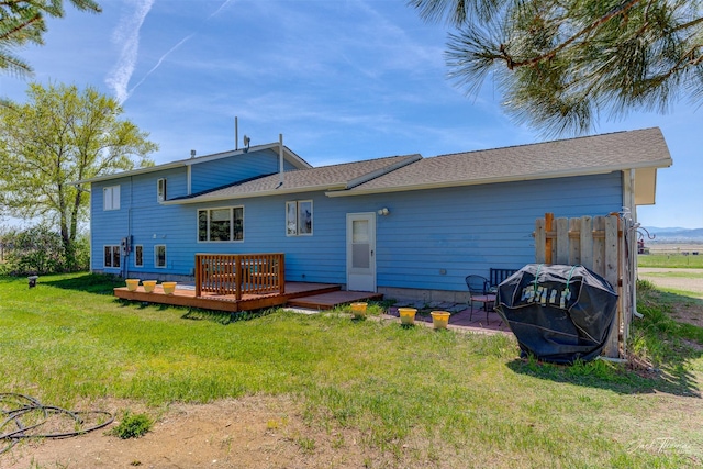 back of house featuring a deck and a yard