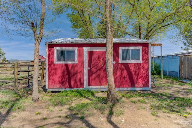 view of shed featuring fence