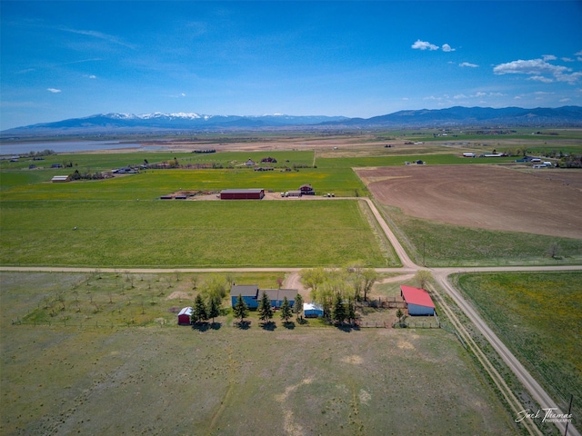 aerial view of sparsely populated area with a mountain backdrop and a pastoral area