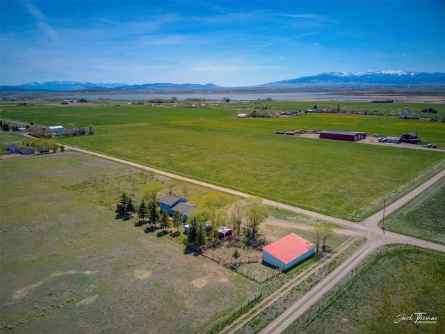 view of rural area with a mountain backdrop and agricultural land