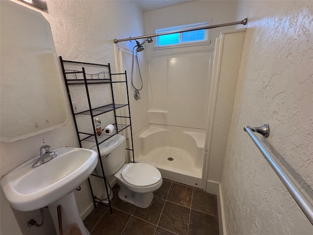 1022 Lewisohn St, Butte, MT 59701 - bathroom featuring walk in shower, a textured wall, and tile patterned flooring