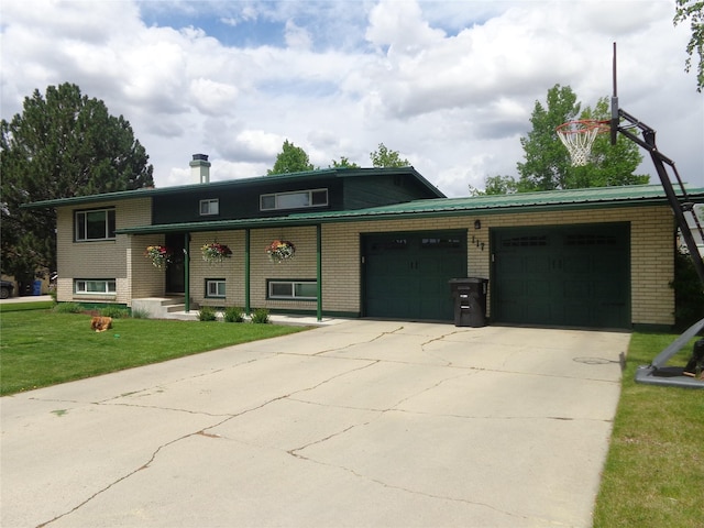 117 Rocky Mountain Ln, Butte, MT 59701 - tri-level home with an attached garage, concrete driveway, a front lawn, and brick siding