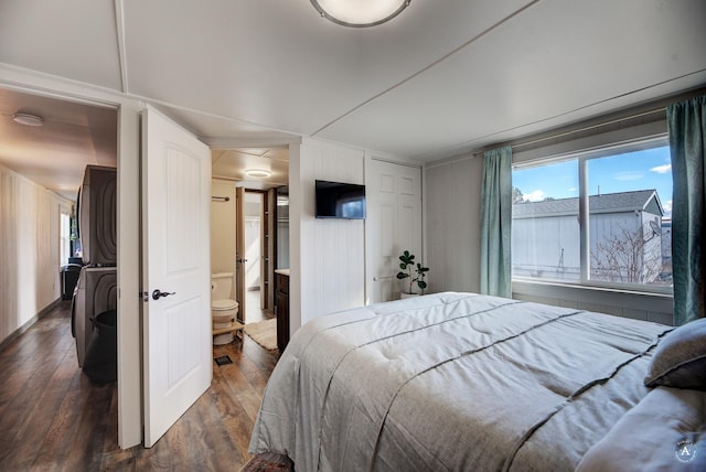 2931 Melrose Rd, Helena, MT 59602 - bedroom with stacked washing machine and dryer, dark wood-type flooring, and ensuite bath