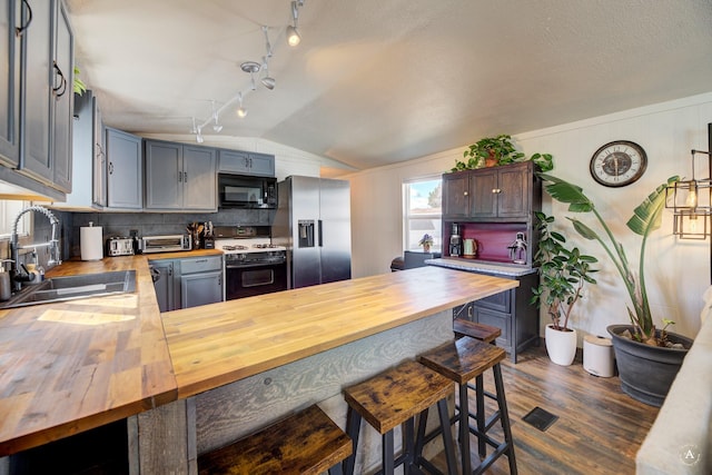 2931 Melrose Rd, Helena, MT 59602 - kitchen with wooden counters, range with gas stovetop, stainless steel fridge with ice dispenser, a sink, and vaulted ceiling