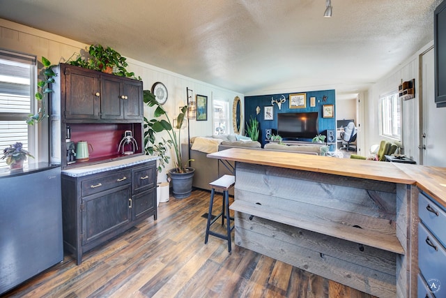 2931 Melrose Rd, Helena, MT 59602 - kitchen with dark wood finished floors, open floor plan, dark brown cabinetry, a textured ceiling, and wood counters