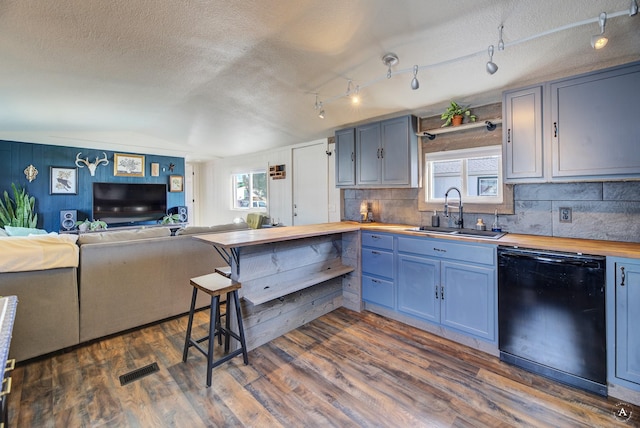 2931 Melrose Rd, Helena, MT 59602 - kitchen featuring wood counters, a sink, black dishwasher, a textured ceiling, and decorative backsplash