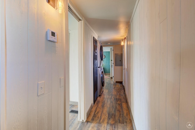 2931 Melrose Rd, Helena, MT 59602 - corridor featuring stacked washer / drying machine, dark wood-style floors, electric panel, and wooden walls