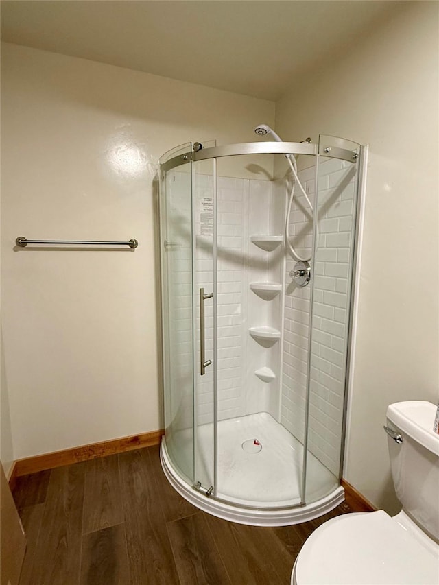 421 Cherry Creek Rd, Thompson Falls, MT 59873 - bathroom with baseboards, toilet, wood finished floors, and a stall shower