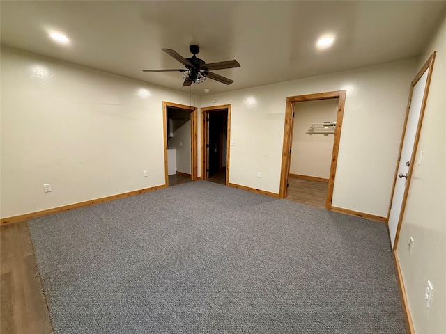 421 Cherry Creek Rd, Thompson Falls, MT 59873 - unfurnished bedroom with a walk in closet, baseboards, carpet floors, recessed lighting, and ensuite bathroom