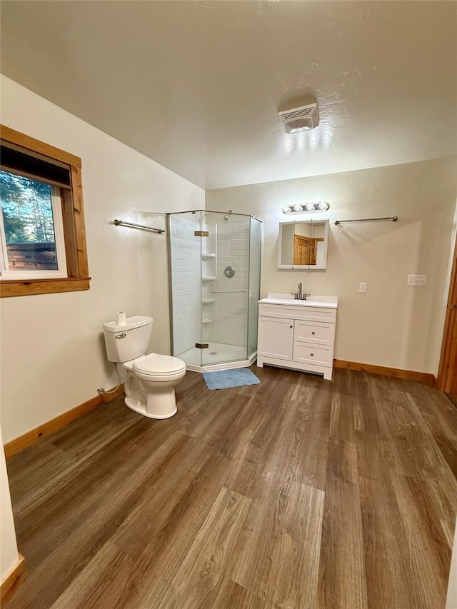 421 Cherry Creek Rd, Thompson Falls, MT 59873 - full bathroom with wood finished floors, vanity, baseboards, a stall shower, and toilet