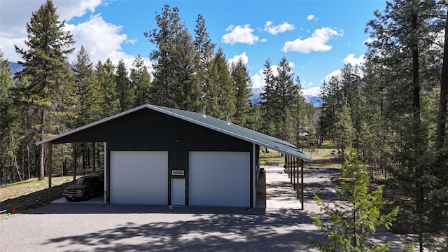 421 Cherry Creek Rd, Thompson Falls, MT 59873 - garage featuring a detached garage and a view of trees
