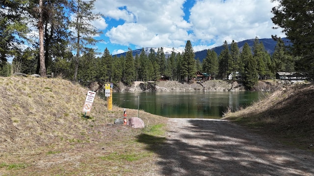 421 Cherry Creek Rd, Thompson Falls, MT 59873 - water view featuring a mountain backdrop and a heavily wooded area