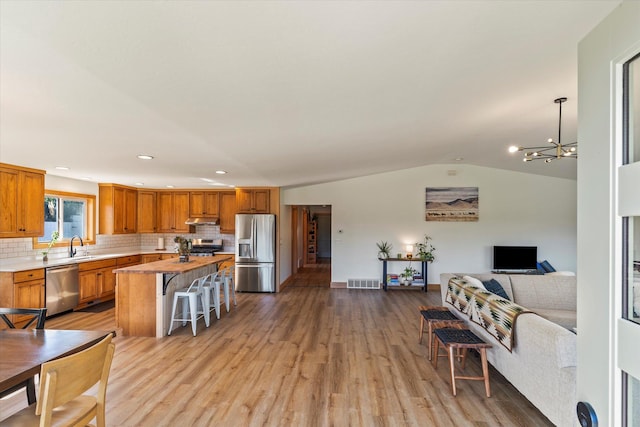 140 Swan River Rd, Bigfork, MT 59911 - living area featuring light wood-type flooring, a chandelier, lofted ceiling, and recessed lighting