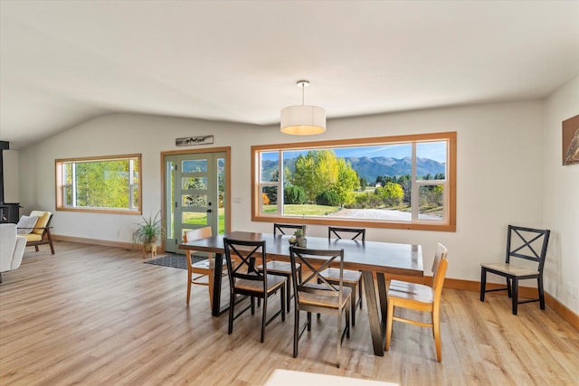 140 Swan River Rd, Bigfork, MT 59911 - dining room featuring light wood finished floors and vaulted ceiling