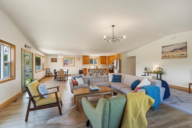140 Swan River Rd, Bigfork, MT 59911 - living room with vaulted ceiling, a chandelier, light wood-style floors, and recessed lighting