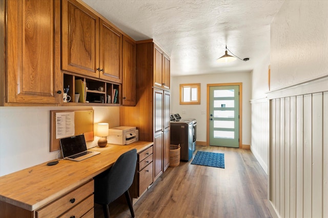 140 Swan River Rd, Bigfork, MT 59911 - office featuring independent washer and dryer, built in study area, wood finished floors, and a textured ceiling