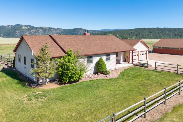 1500 Mt Highway 83, Greenough, MT 59823 - single story home featuring a chimney, a mountain view, roof with shingles, and a garage