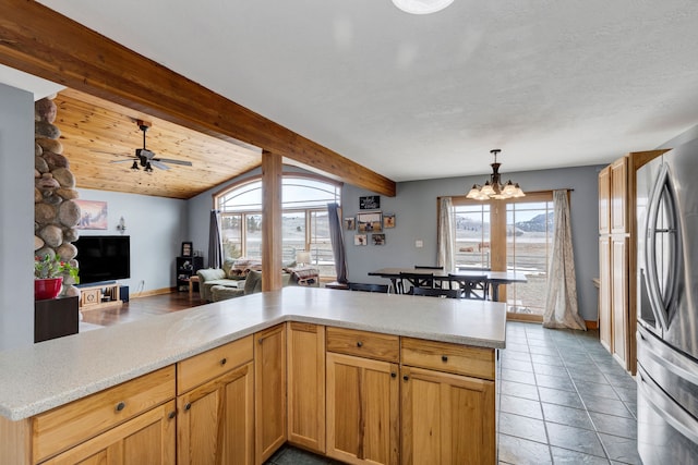 1500 Mt Highway 83, Greenough, MT 59823 - kitchen with freestanding refrigerator, a chandelier, light countertops, open floor plan, and ceiling fan