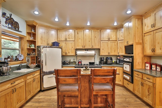 133 Klakken Rd, Noxon, MT 59853 - kitchen with open shelves, black oven, light wood-type flooring, and freestanding refrigerator