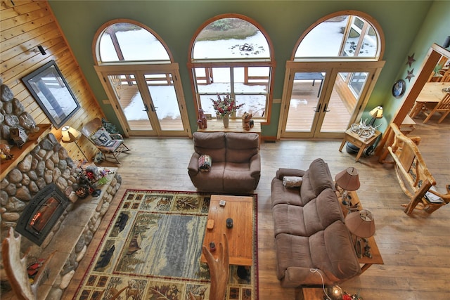 133 Klakken Rd, Noxon, MT 59853 - living area featuring french doors, a towering ceiling, wood walls, hardwood / wood-style floors, and a fireplace