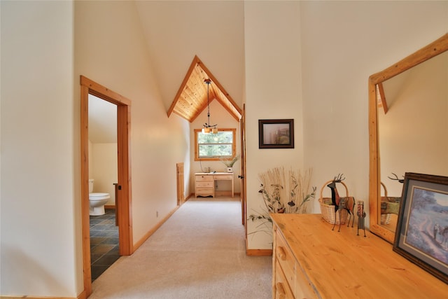 133 Klakken Rd, Noxon, MT 59853 - hallway featuring baseboards, a towering ceiling, and light colored carpet