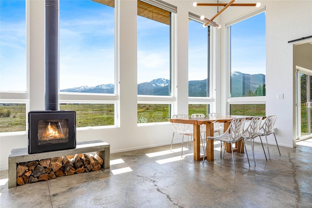5052 Hoblitt Ln N, Florence, MT 59833 - sunroom / solarium with a mountain view and a wood stove