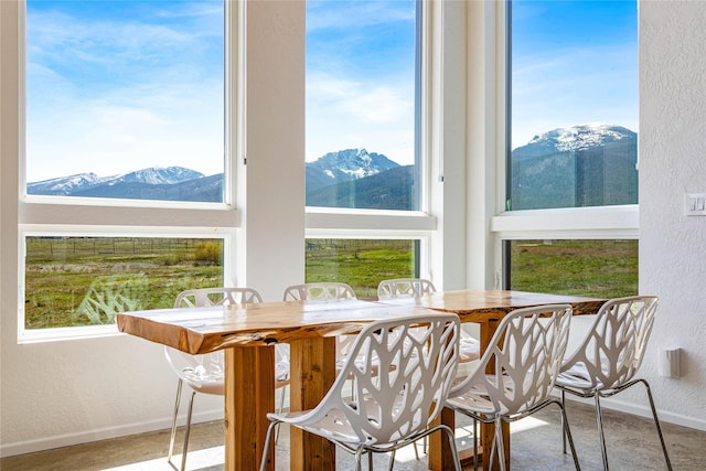 5052 Hoblitt Ln N, Florence, MT 59833 - dining space featuring a mountain view, baseboards, and a textured wall