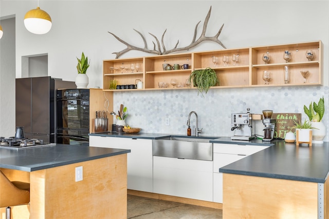 5052 Hoblitt Ln N, Florence, MT 59833 - kitchen with a sink, dark countertops, white cabinetry, open shelves, and backsplash