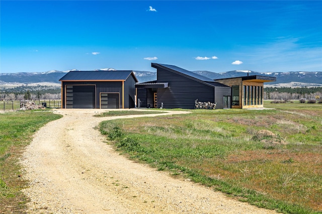 5052 Hoblitt Ln N, Florence, MT 59833 - view of outbuilding featuring an outdoor structure, dirt driveway, and a mountain view