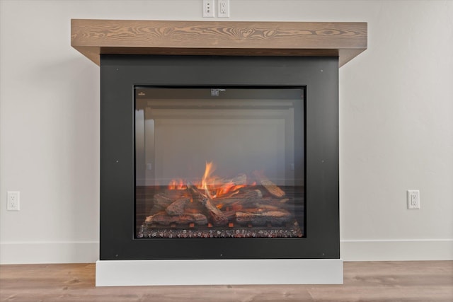 1048 Mill Creek Dr, Bigfork, MT 59911 - detailed view of wood finished floors and a glass covered fireplace