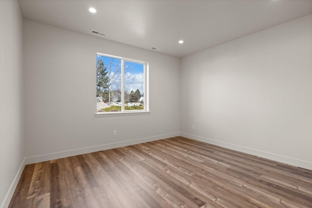 1048 Mill Creek Dr, Bigfork, MT 59911 - unfurnished room with baseboards, wood finished floors, and recessed lighting