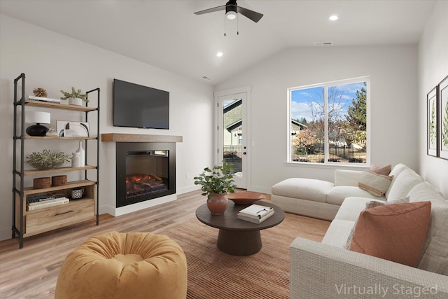 1048 Mill Creek Dr, Bigfork, MT 59911 - living area with ceiling fan, lofted ceiling, light wood-style flooring, a glass covered fireplace, and recessed lighting