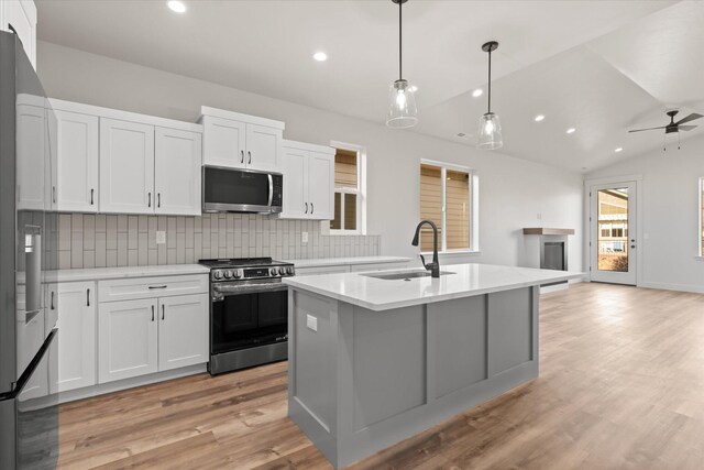 1048 Mill Creek Dr, Bigfork, MT 59911 - kitchen with appliances with stainless steel finishes, a sink, light wood finished floors, recessed lighting, and tasteful backsplash